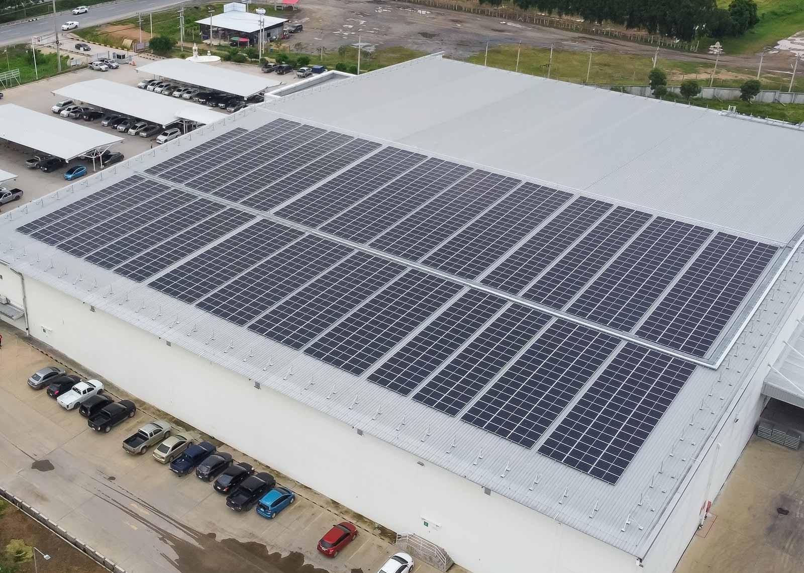Solar panels installed on the roof of a warehouse.